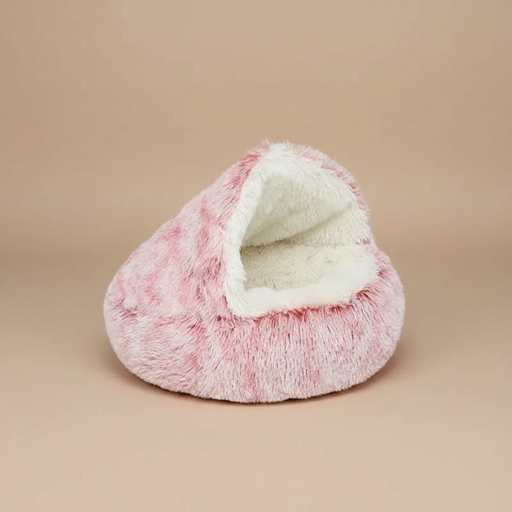 Pink plush pet bed with white interior on a white background
