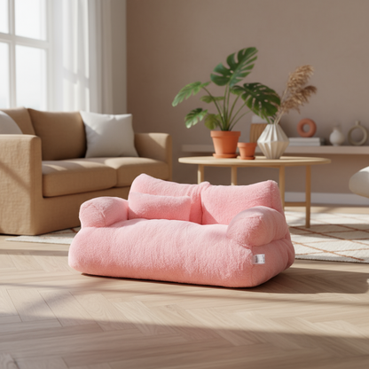 Pink pet bed on a carpeted floor with a lamp and decorative items in the background