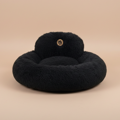 black fluffy donut bed with a visible brand logo.