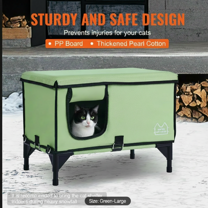 Green pet shelter with a cat inside, surrounded by firewood and snow.