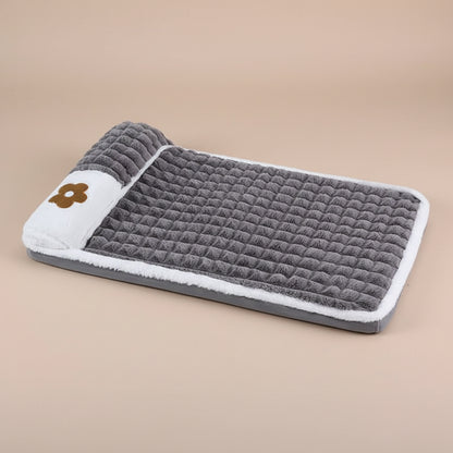 Gray textured pet mat with white border and brown logo on a beige background