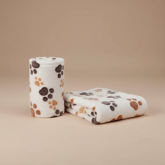 Folded blanket with paw print pattern on a beige background
