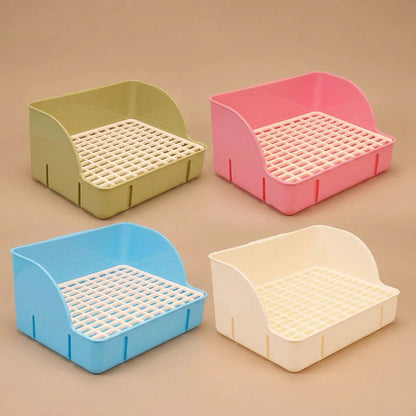 Four colorful pet litter boxes on a beige background