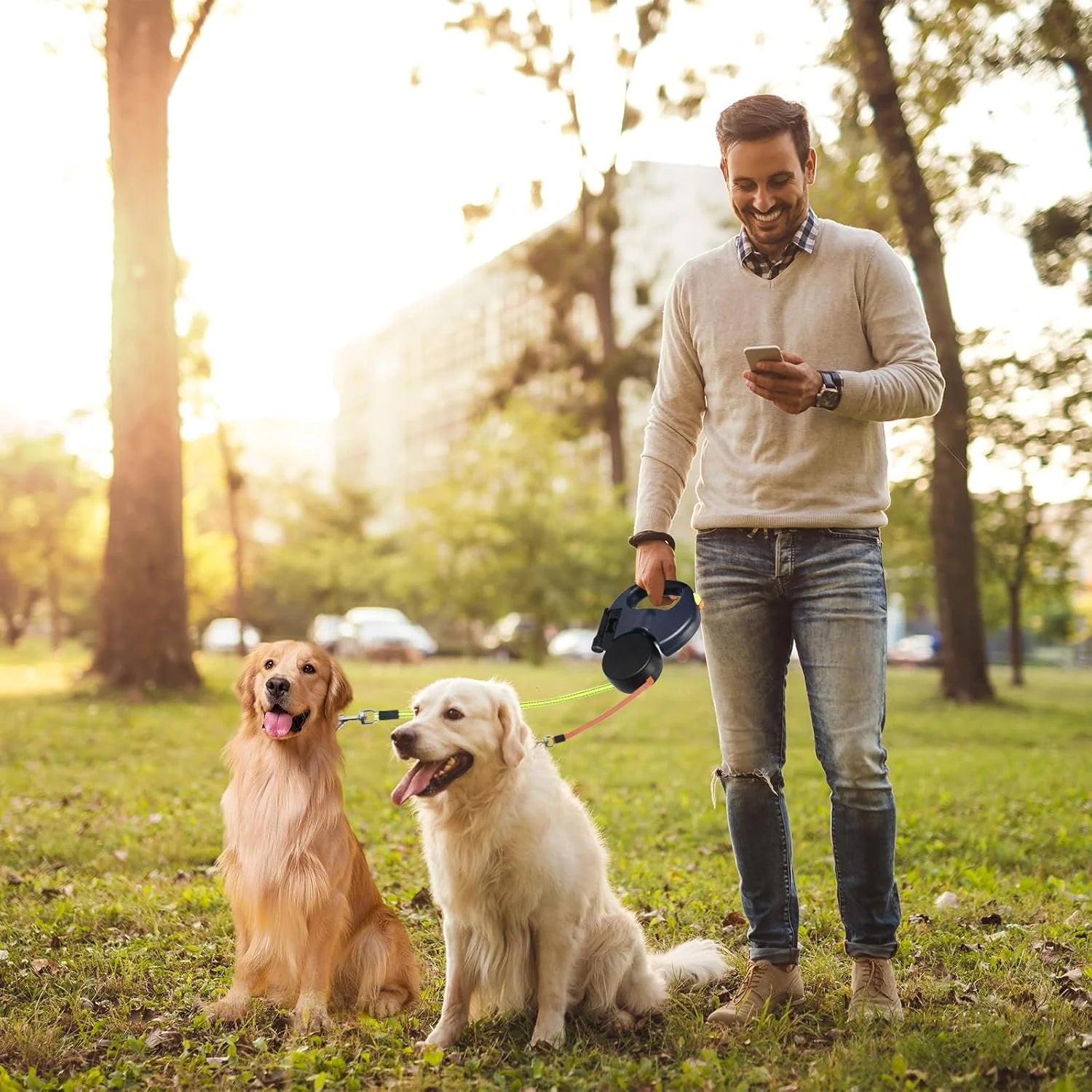 A Man using the Dual Pet Leash Retractable Double Dog Walking Leash in the park with his dogs