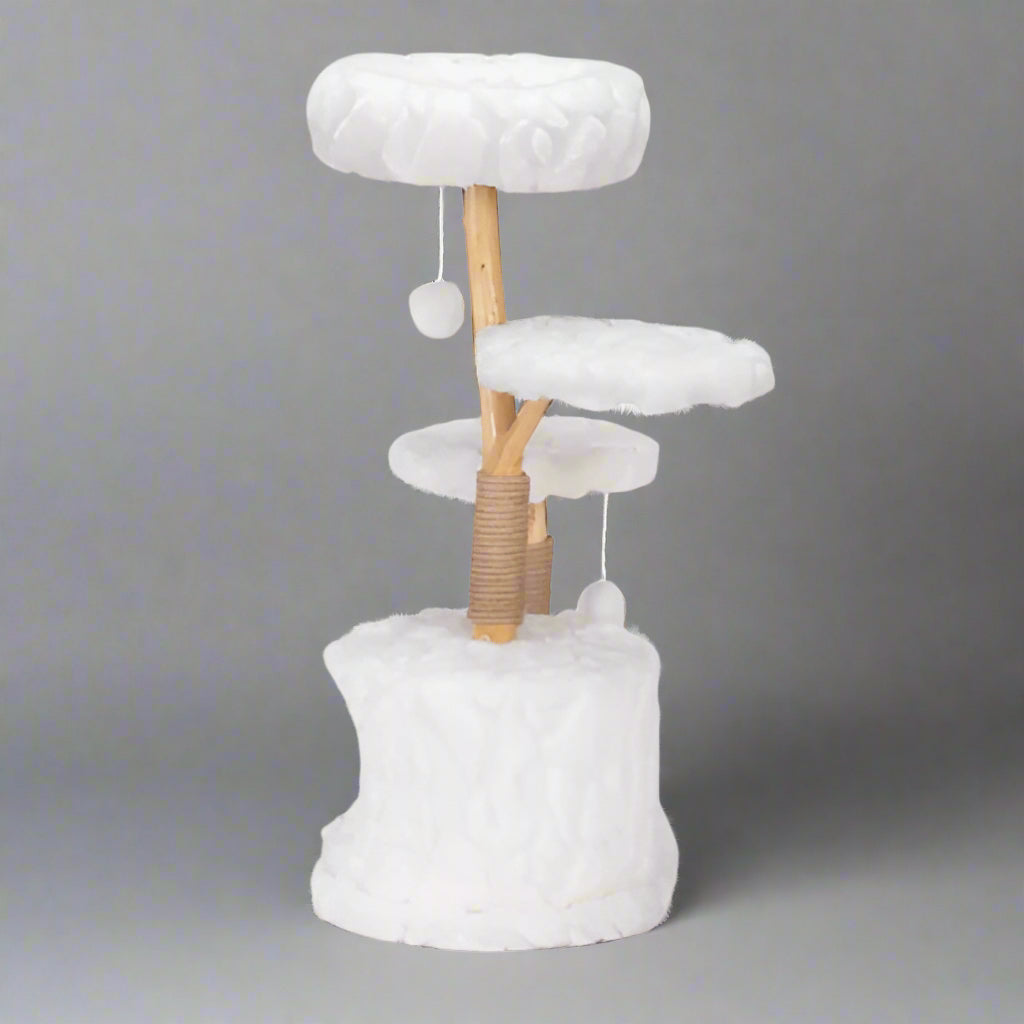 Cat tree with white cushioned platforms and a wooden post on a white background