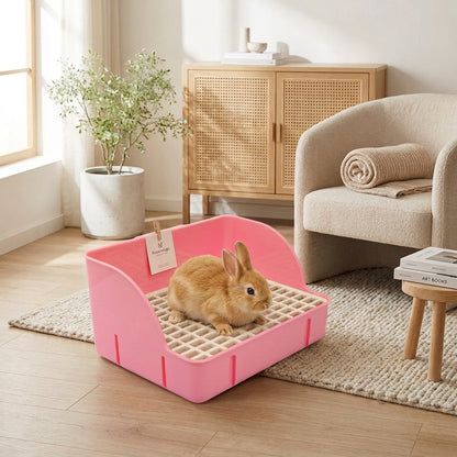 Small brown rabbit inside a pink pet litter tray on a light wooden floor.