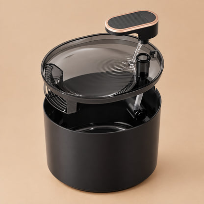 Black pet water fountain with transparent top on a beige background