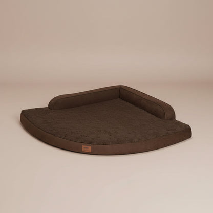 Image of a brown pet bed with a beige background.