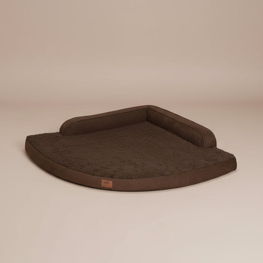 Image of a brown pet bed with a beige background.