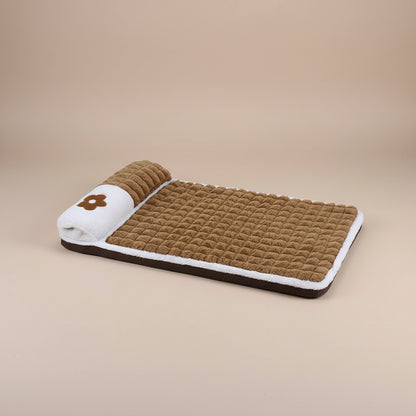 Brown pet bed with white border and flower design on a tan background