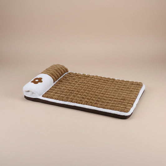 Brown pet bed with white border and flower design on a tan background