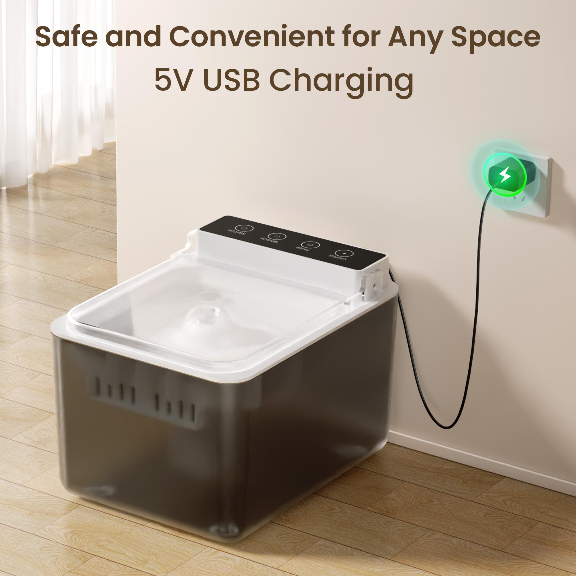 Pet water bowl with USB charging cable plugged into a wall socket on a wooden floor.
