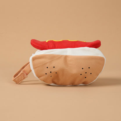 Plush costume shaped like a hot dog with a bun on a beige background