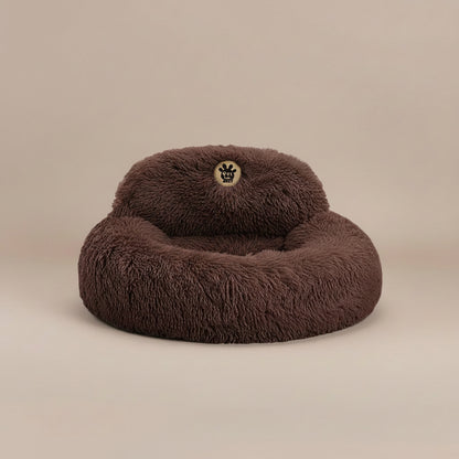 brown fluffy pet bed with a visible brand logo.