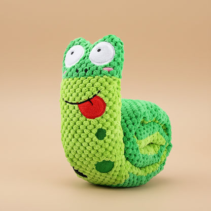 Green crocheted toy with a face on a white background
