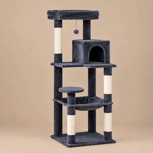 A multi-level cat tree with dark gray plush fabric, sisal-wrapped scratching posts, a small enclosed cat bed, a hanging toy ball, a perch, and a hammock, photographed on a plain beige studio background.
