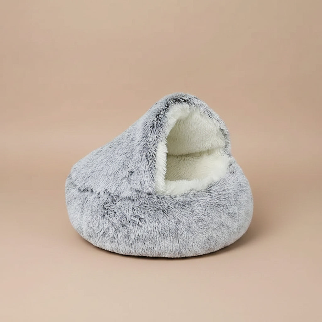 Gray plush pet bed with white interior on a white background