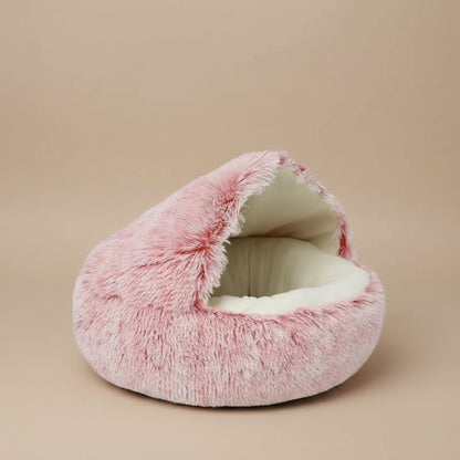 Pink fluffy pet bed with a label indicating the color on a white background